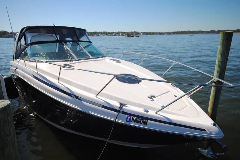  Yacht Photos Pics 2015 Regal 32 Express boat docked on calm water under clear blue sky.