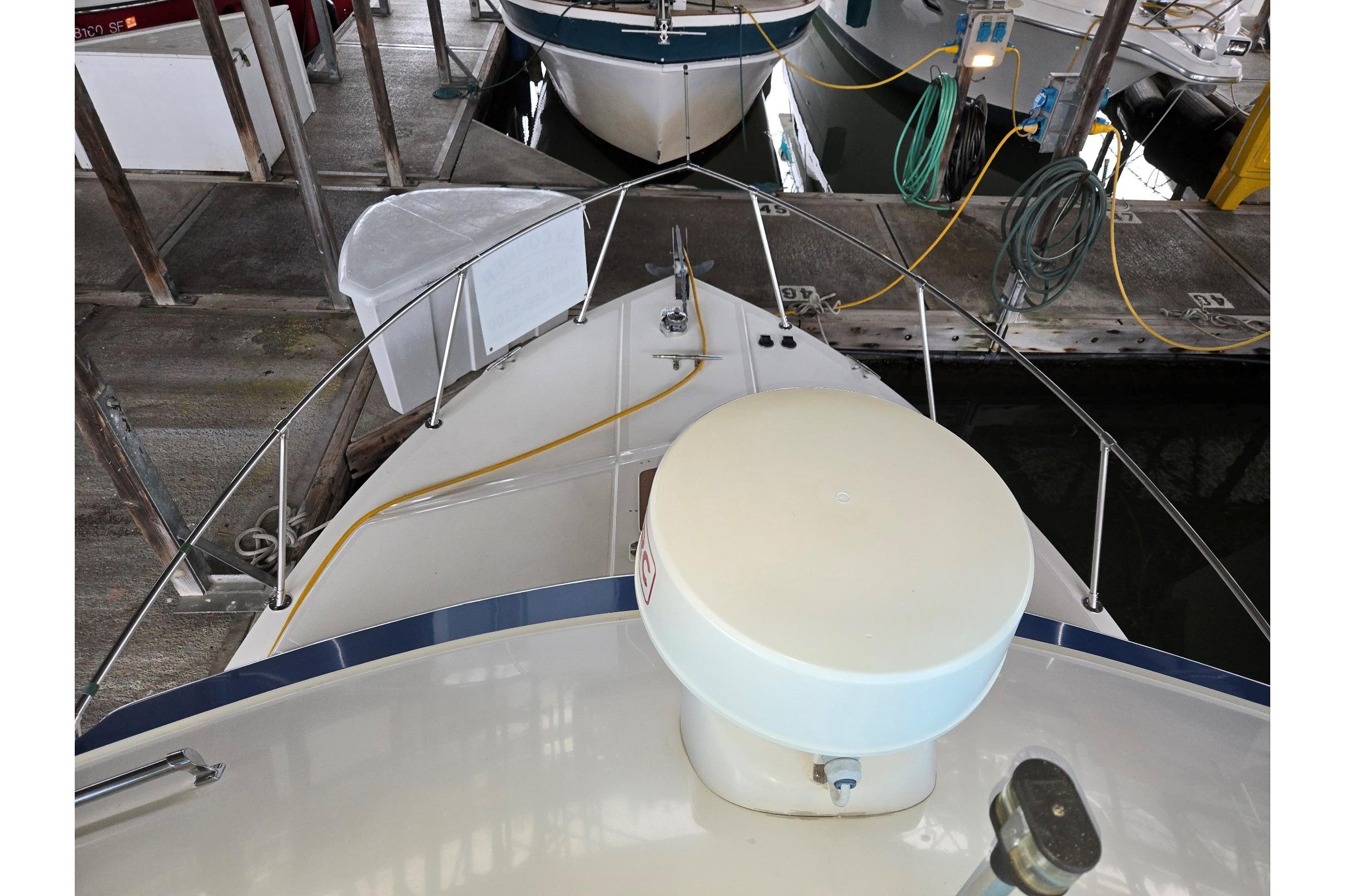 2001 Commander Flybridge Sedan docked, showing bow and marina setup.