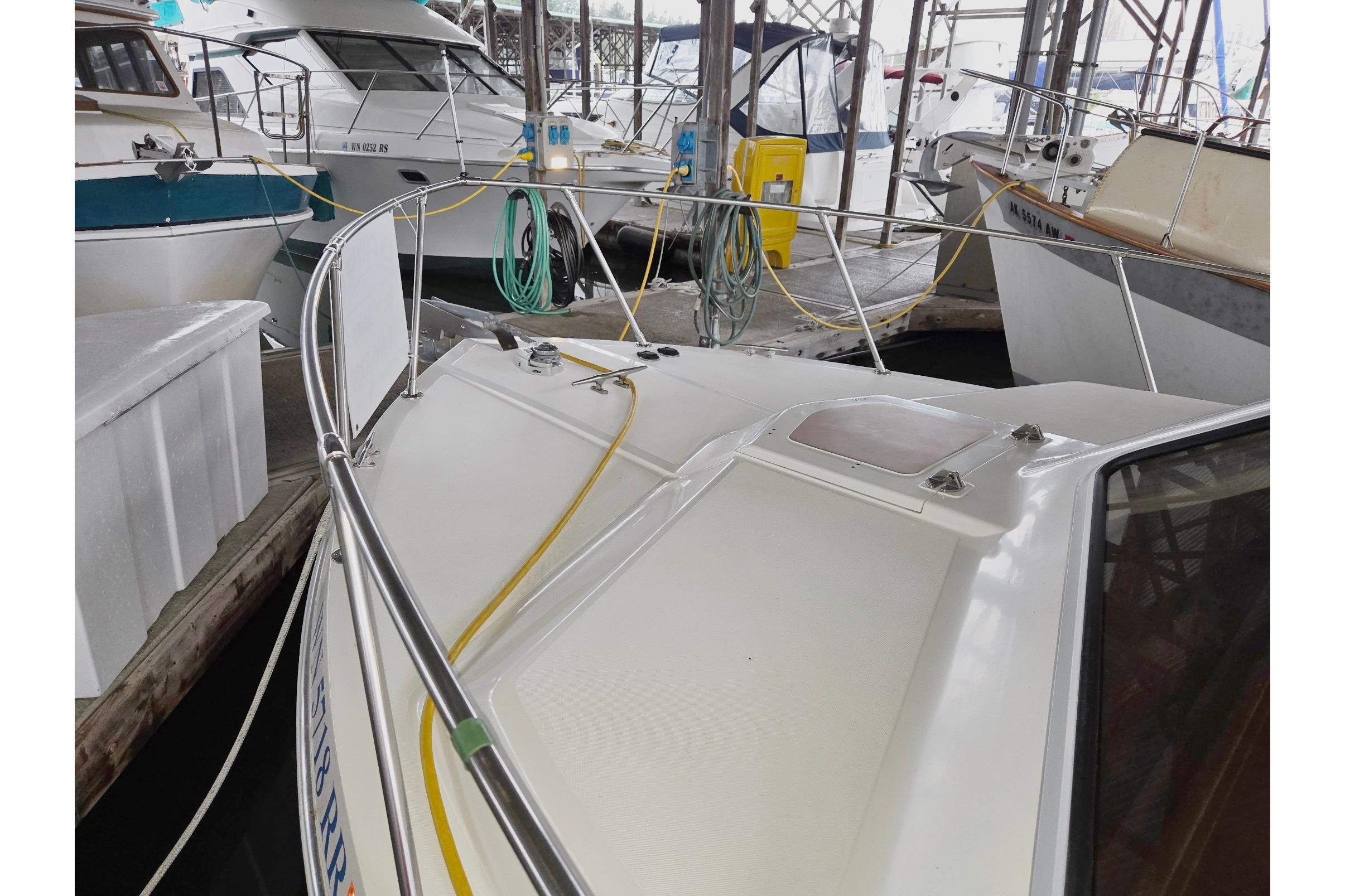 2001 Commander Flybridge Sedan docked in a marina with other boats.