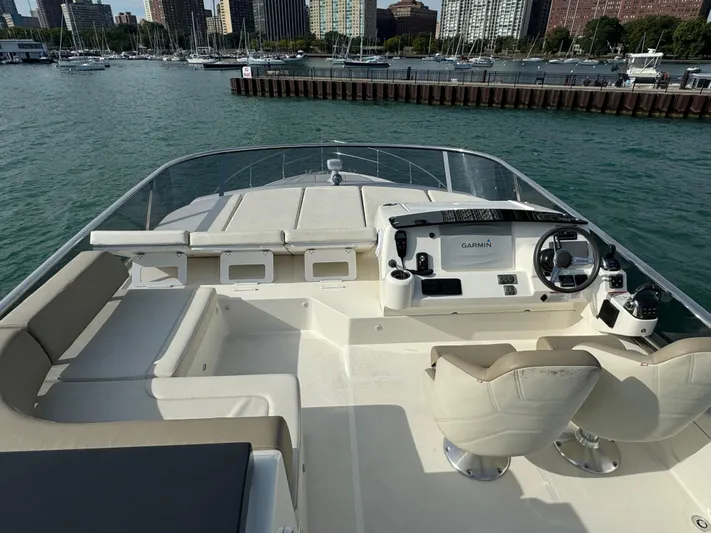  Yacht Photos Pics Flybridge of 2017 Absolute 50 Fly yacht with helm and seating, docked in a marina.