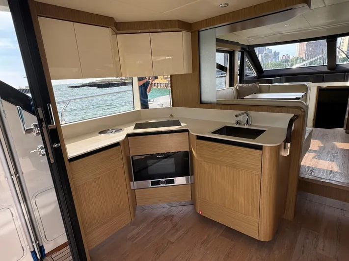  Yacht Photos Pics Luxurious interior of 2017 Absolute 50 Fly yacht with modern kitchen and scenic water view.