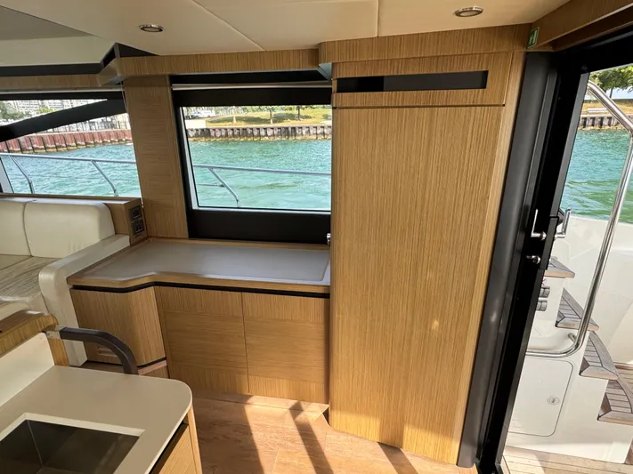  Yacht Photos Pics Interior of 2017 Absolute 50 Fly yacht with wooden cabinetry and large window view.