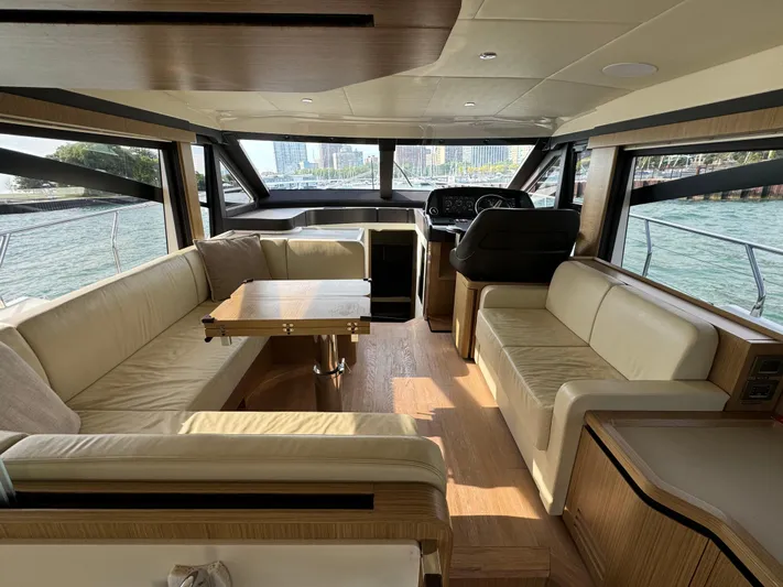  Yacht Photos Pics Luxurious interior of a 2017 Absolute 50 Fly yacht with beige seating and wooden accents.