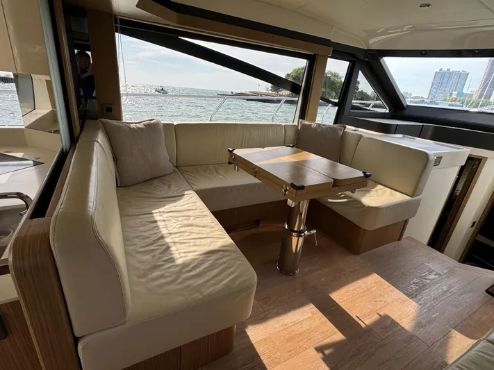  Yacht Photos Pics Luxurious interior of 2017 Absolute 50 Fly yacht with elegant seating and table.