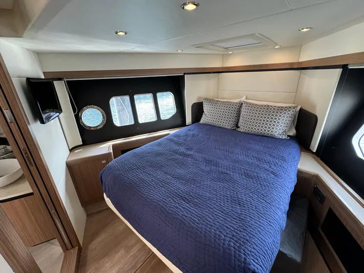  Yacht Photos Pics Luxurious cabin interior of 2017 Absolute 50 Fly yacht with cozy bed and porthole windows.