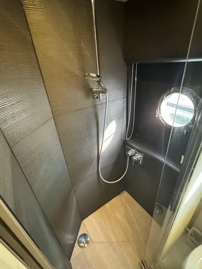  Yacht Photos Pics Luxurious shower in 2017 Absolute 50 Fly yacht with modern fixtures and porthole window.