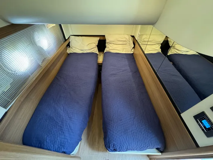  Yacht Photos Pics Twin beds with blue covers in a 2017 Absolute 50 Fly yacht cabin.