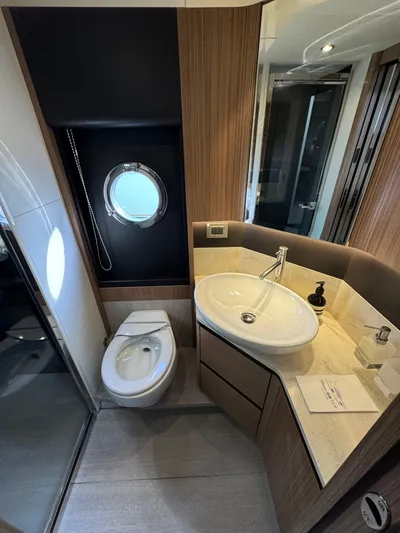  Yacht Photos Pics Luxurious bathroom in 2017 Absolute 50 Fly yacht with modern fixtures and porthole window.
