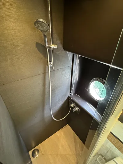  Yacht Photos Pics Shower area in 2017 Absolute 50 Fly yacht with porthole and modern fixtures.