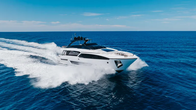 Kiyomizu Yacht Photos Pics Luxury Riva 90 Argo yacht cruising on open sea, 2020 model, under clear blue sky.