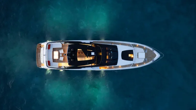 Kiyomizu Yacht Photos Pics Aerial view of 2020 Riva 90 Argo yacht illuminated on blue water.