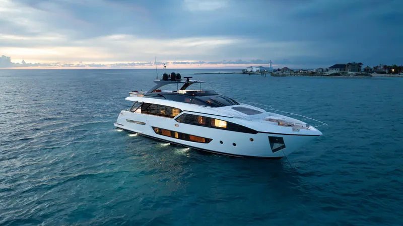 Kiyomizu Yacht Photos Pics Luxurious 2020 Riva 90 Argo yacht cruising at sunset on tranquil waters.