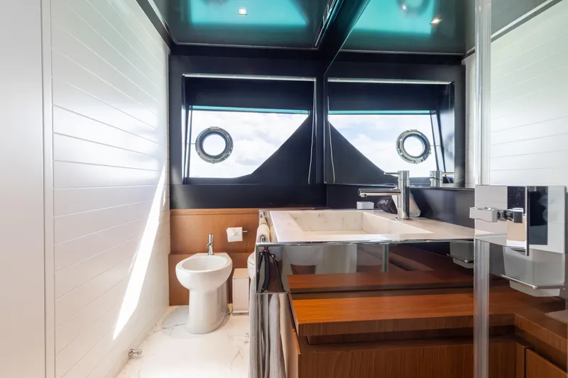 Kiyomizu Yacht Photos Pics Luxurious bathroom interior of 2020 Riva 90 Argo yacht with modern fixtures and porthole windows.