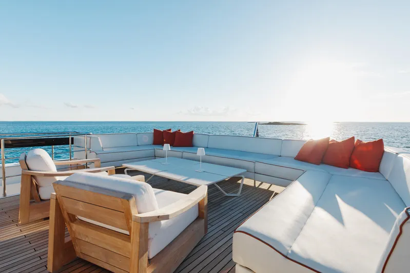 Kiyomizu Yacht Photos Pics Luxurious Riva 90 Argo yacht deck with elegant seating, ocean view, and sunset ambiance.