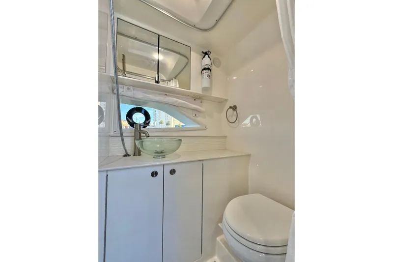  Yacht Photos Pics 2022 Sea Ray Sundancer 320 bathroom with modern sink, mirror, and toilet.