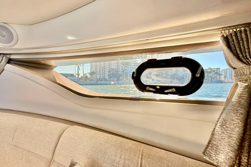  Yacht Photos Pics Interior view of 2022 Sea Ray Sundancer 320 yacht window overlooking water and cityscape.