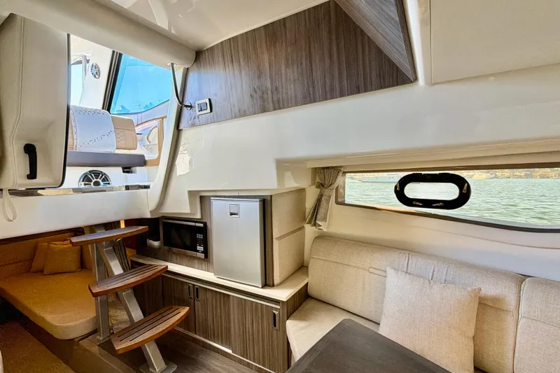 Yacht Photos Pics Interior of 2022 Sea Ray Sundancer 320 yacht, featuring modern seating and compact kitchen area.