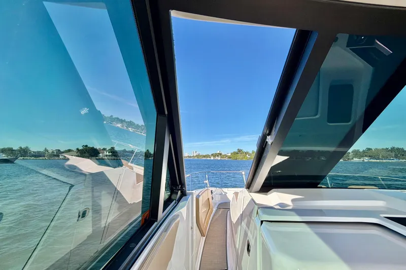  Yacht Photos Pics 2022 Sea Ray Sundancer 320 yacht with open sunroof, overlooking serene waters.