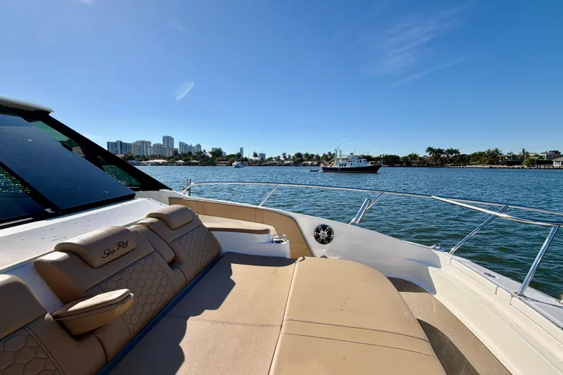  Yacht Photos Pics 2022 Sea Ray Sundancer 320 yacht on calm water with city skyline.