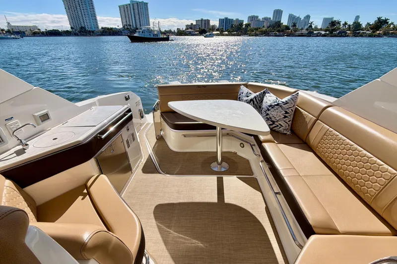  Yacht Photos Pics Luxurious 2022 Sea Ray Sundancer 320 yacht interior with elegant seating and scenic waterfront view.