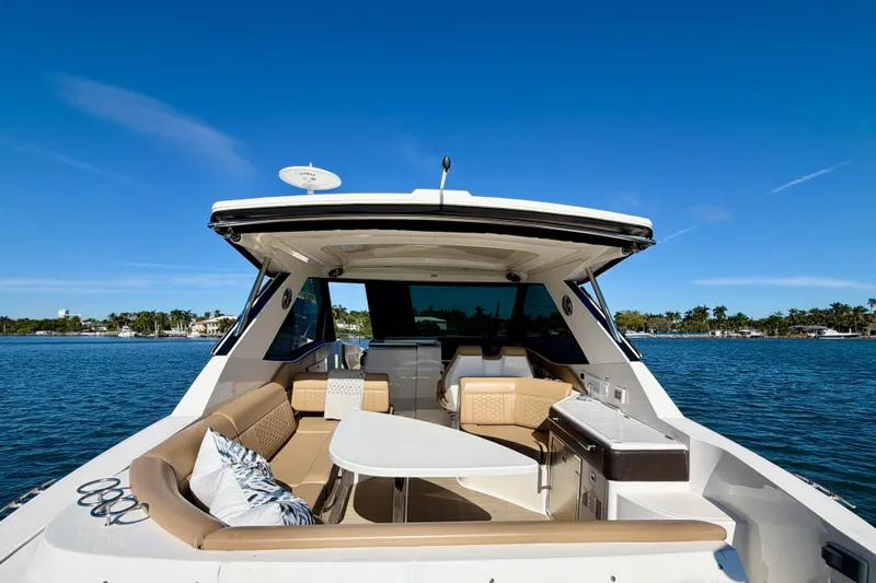  Yacht Photos Pics 2022 Sea Ray Sundancer 320 yacht interior with seating, table, and ocean view.