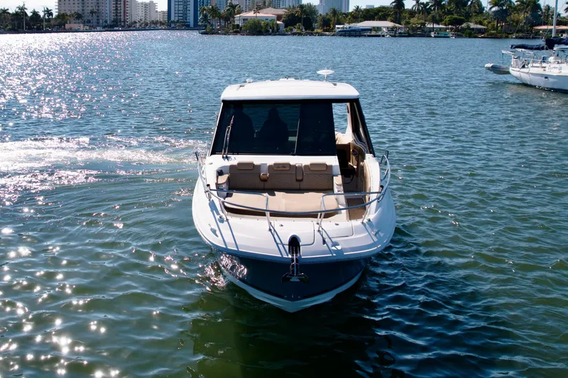  Yacht Photos Pics 2022 Sea Ray Sundancer 320 cruising on a sunny day in a scenic waterway.