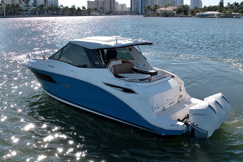  Yacht Photos Pics 2022 Sea Ray Sundancer 320 cruising on a sunny day, showcasing sleek design and powerful engines.