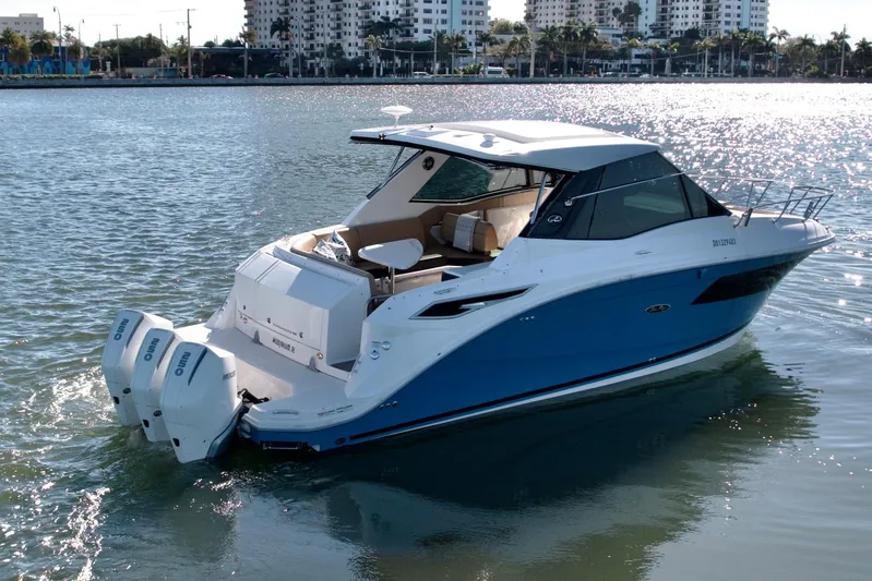 Yacht Photos Pics 2022 Sea Ray Sundancer 320 boat on water, cityscape background, sunny day.