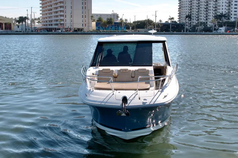  Yacht Photos Pics 2022 Sea Ray Sundancer 320 yacht cruising in urban waterfront setting.