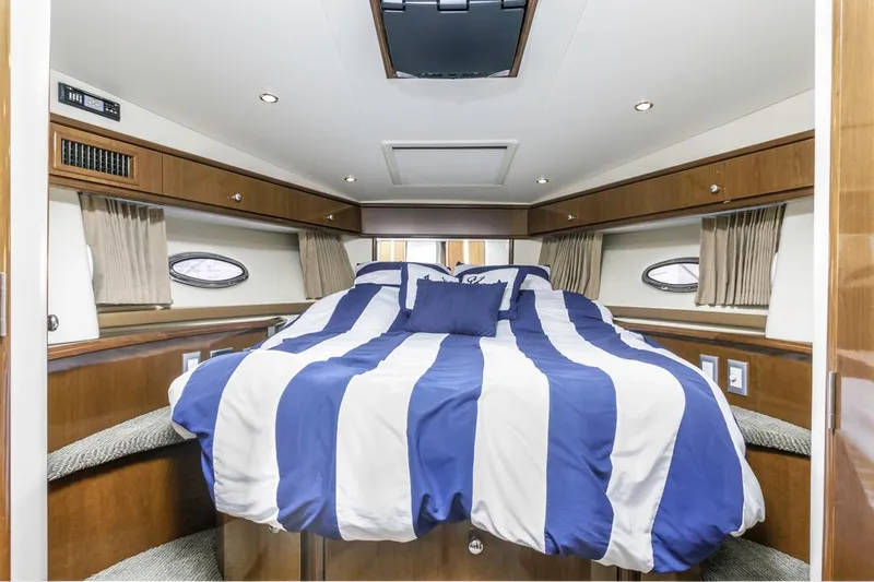 Aloha Ke Akua Yacht Photos Pics Luxurious cabin interior of 2007 Carver 42 Super Sport yacht with striped bedding.