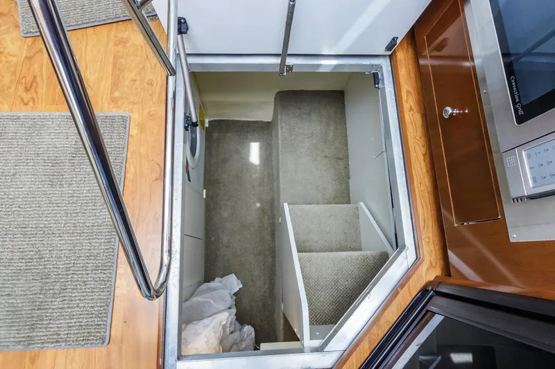 Aloha Ke Akua Yacht Photos Pics Interior view of 2007 Carver 42 Super Sport yacht showing carpeted stairs and wooden flooring.