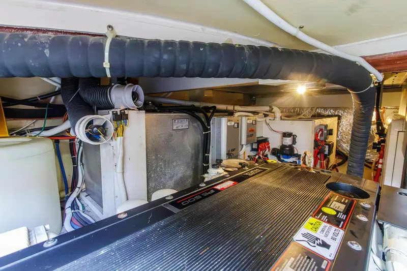 Aloha Ke Akua Yacht Photos Pics Engine room of 2007 Carver 42 Super Sport yacht, showcasing mechanical components and systems.
