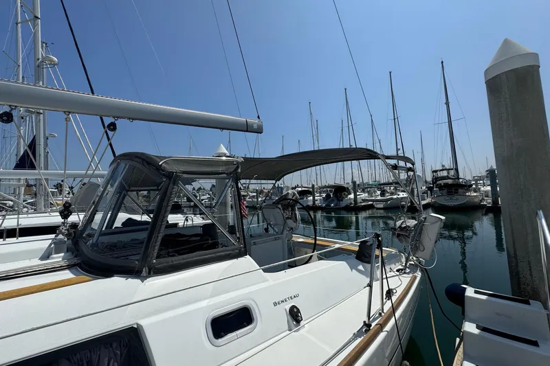 Mi Fuego Yacht Photos Pics 2017 Beneteau Oceanis 37 sailboat docked in a marina under clear blue skies.