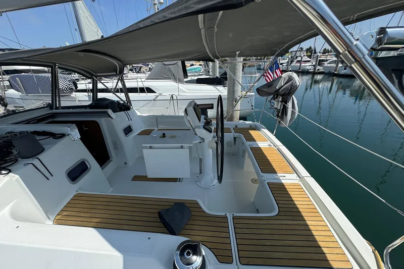 Mi Fuego Yacht Photos Pics 2017 Beneteau Oceanis 37 sailboat cockpit with teak flooring and marina view.