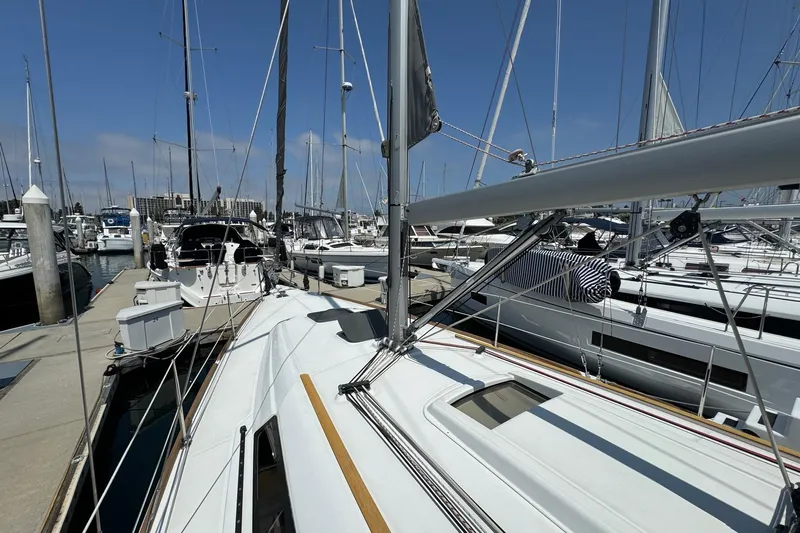 Mi Fuego Yacht Photos Pics 2017 Beneteau Oceanis 37 sailboat docked at a marina under clear blue skies.