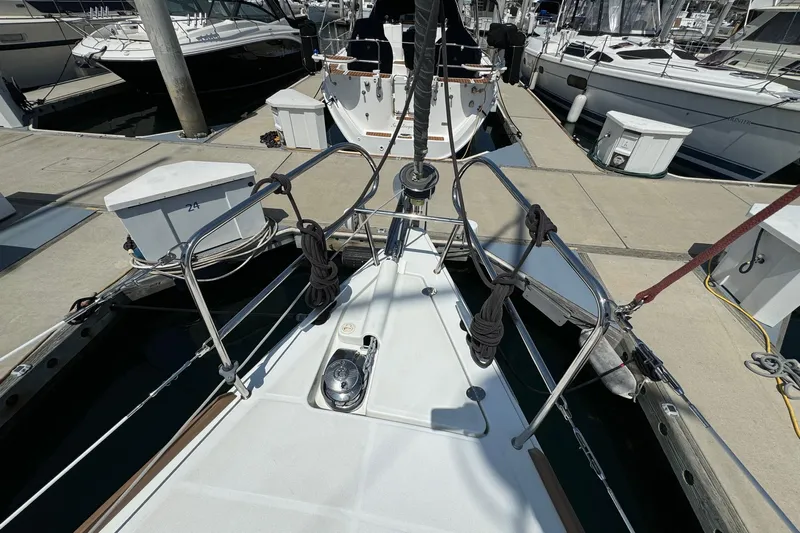 Mi Fuego Yacht Photos Pics Bow view of a 2017 Beneteau Oceanis 37 yacht docked at a marina.