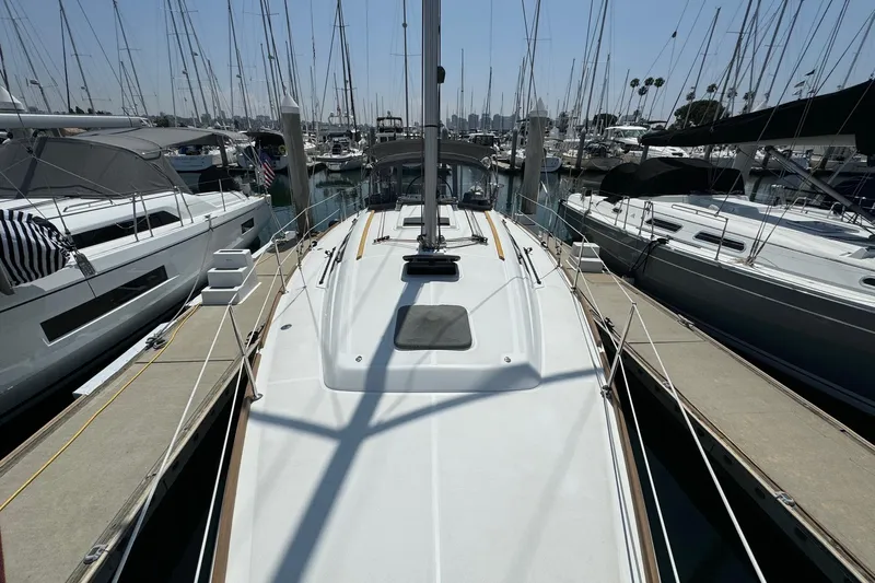 Mi Fuego Yacht Photos Pics 2017 Beneteau Oceanis 37 sailboat docked at marina, surrounded by other yachts.