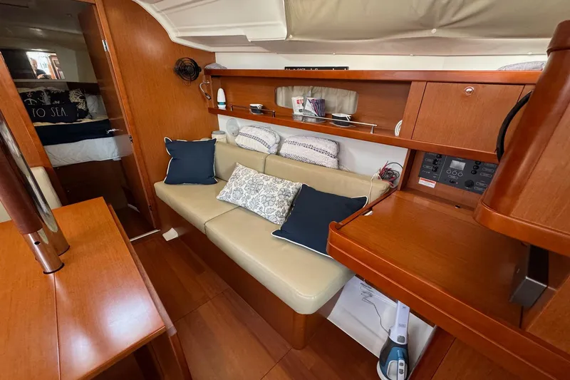 Mi Fuego Yacht Photos Pics Interior of 2017 Beneteau Oceanis 37 sailboat with cozy seating and wooden finishes.