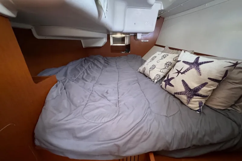 Mi Fuego Yacht Photos Pics Cozy cabin interior of 2017 Beneteau Oceanis 37 with starfish-themed pillows.