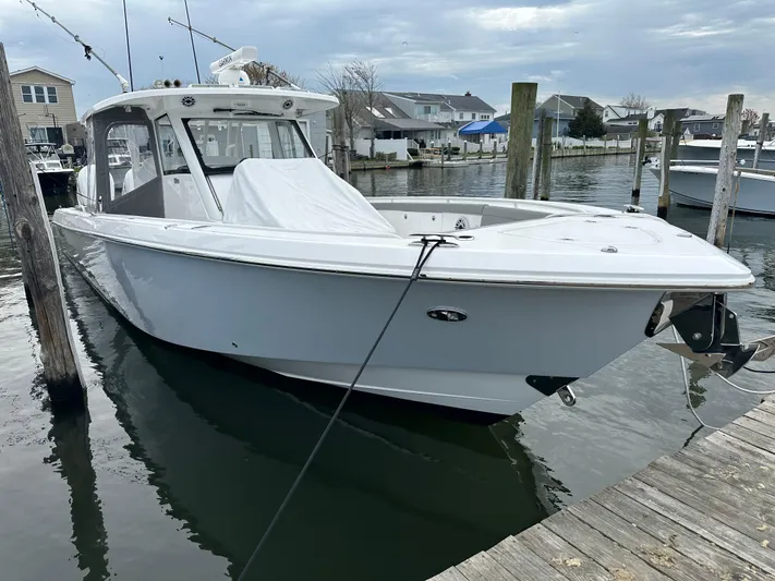  Yacht Photos Pics 2023 Everglades 395 Center Console boat docked in a marina.