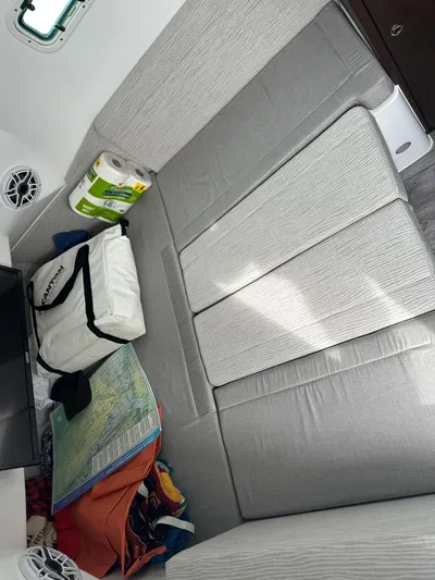  Yacht Photos Pics 2023 Everglades 395 Center Console cabin interior with seating and storage.