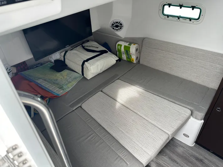  Yacht Photos Pics Interior cabin of 2023 Everglades 395 Center Console with bed, TV, and storage.
