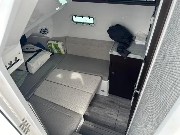  Yacht Photos Pics Interior cabin of 2023 Everglades 395 Center Console boat with seating and storage.