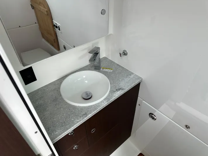  Yacht Photos Pics 2023 Everglades 395 Center Console bathroom with modern sink and countertop.