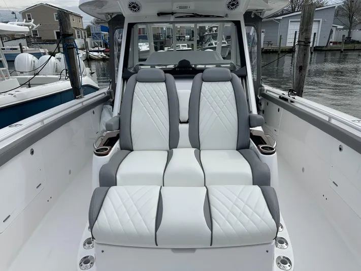  Yacht Photos Pics 2023 Everglades 395 Center Console boat with luxurious seating at a marina.