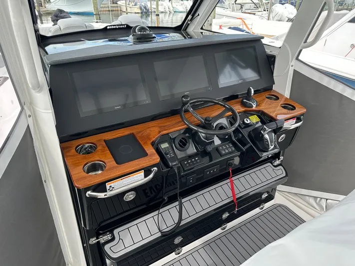 Yacht Photos Pics 2023 Everglades 395 Center Console helm with advanced navigation screens and controls.
