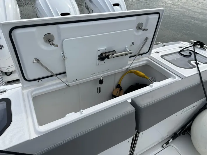  Yacht Photos Pics 2023 Everglades 395 Center Console storage compartment with open lid.