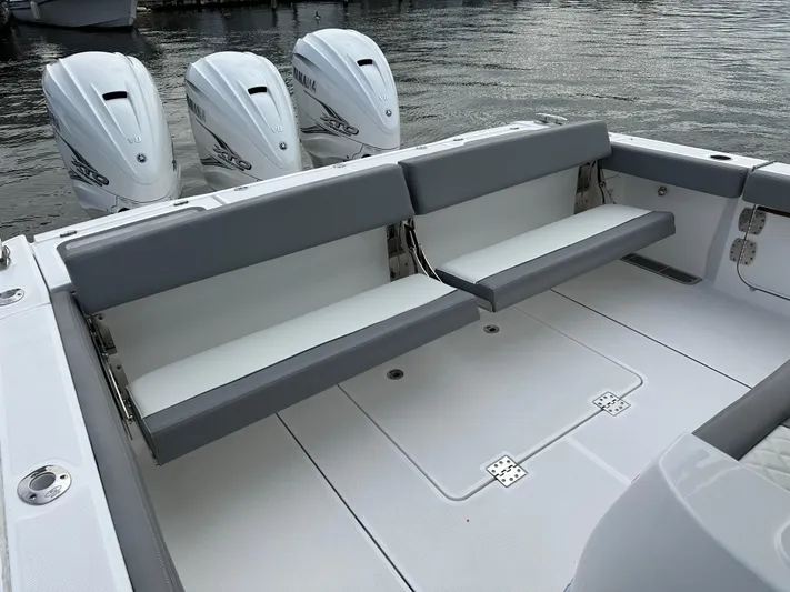  Yacht Photos Pics 2023 Everglades 395 Center Console boat with triple outboard engines and foldable seating.