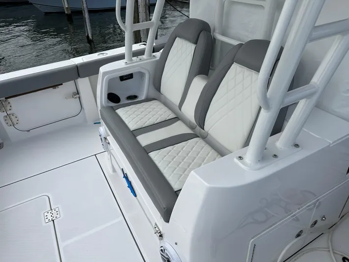  Yacht Photos Pics 2023 Everglades 395 Center Console boat seating area with white and gray upholstery.
