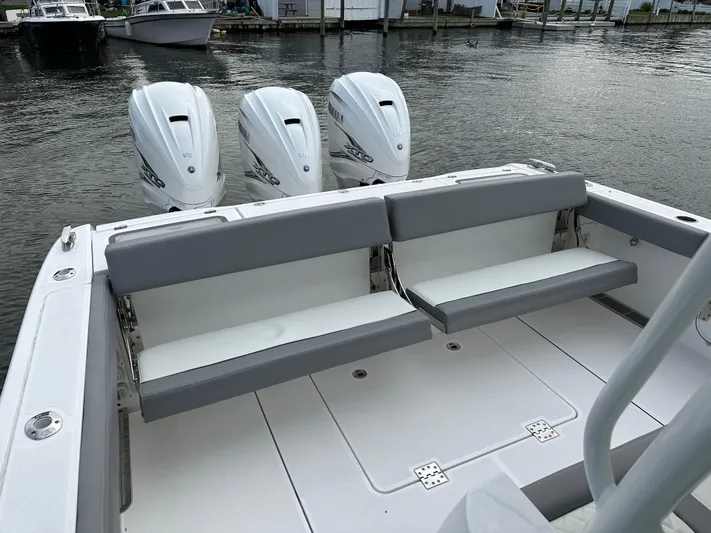  Yacht Photos Pics 2023 Everglades 395 Center Console boat with triple outboard engines and rear seating.
